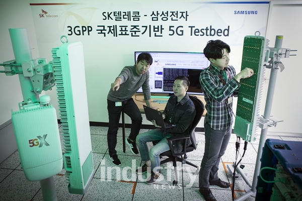 SK텔레콤과 삼성전자 연구원들이 15일 SK텔레콤 분당사옥 5G 테스트베드에서 3.5GHz 대역 5G상용 장비를 다루고 있다. [사진=SK텔레콤]